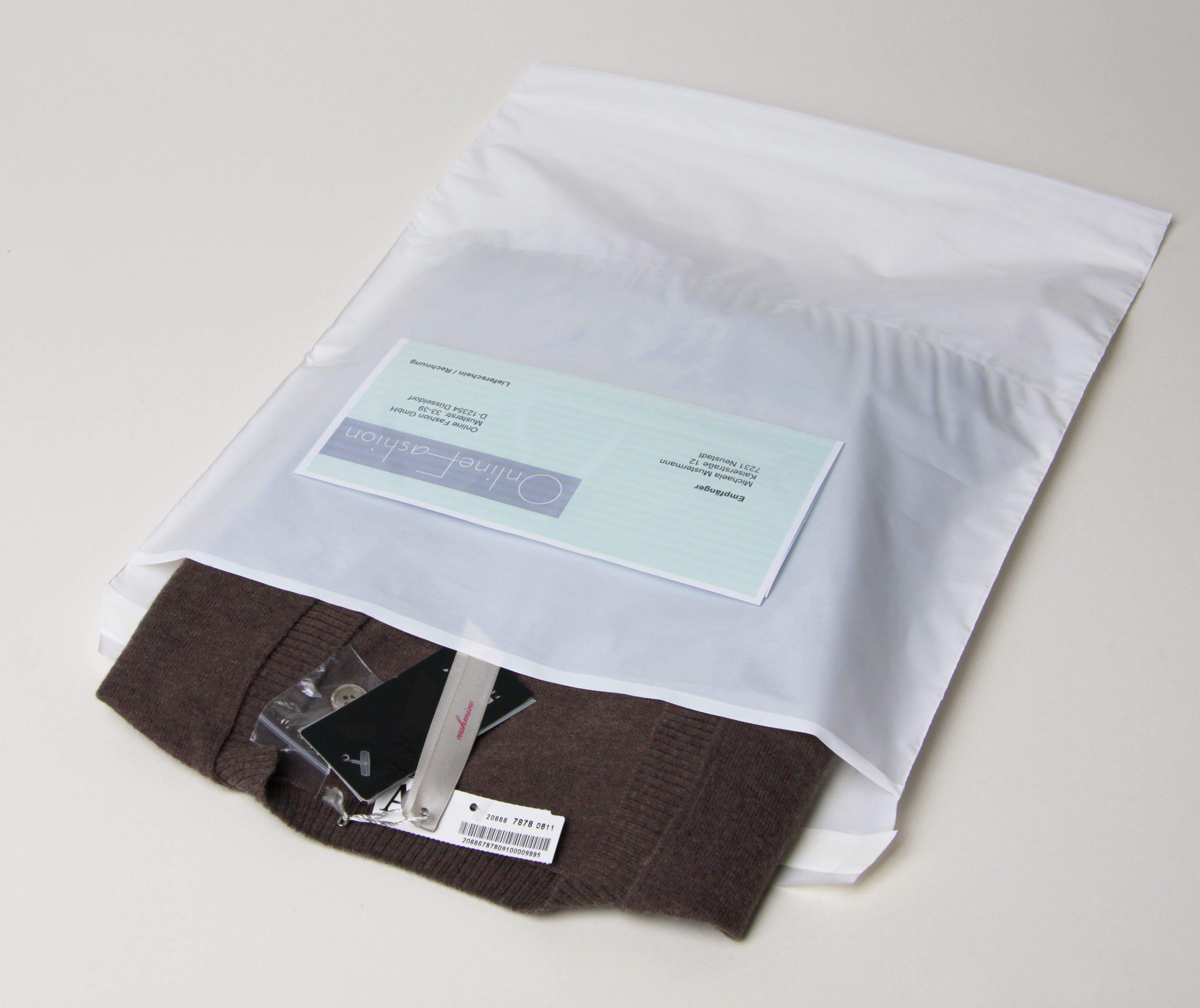 Textilversandbeutel 390x430+50 weiß 60µ+Zusatztasche transp.